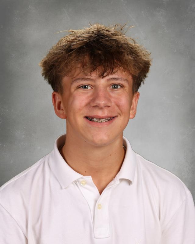 Portrait of Brady Richart wearing a headset in a control room